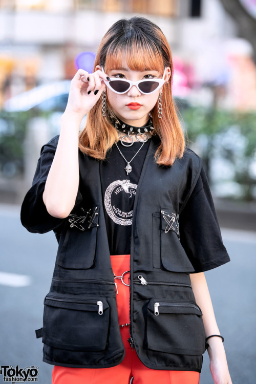 Japanese teens Maria and Megumi on the street in Harajuku wearing chokers, utility vests, and boots 