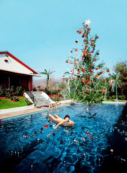vintagegal:  Rita Aarons, wife of photographer Slim Aarons, swimming in a pool festooned with floating baubles and a decorated Christmas tree, Hollywood, California, 1954.(via) 