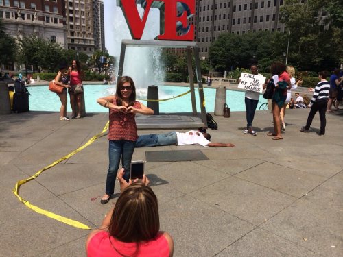 thatblackveganguy:  ras-al-ghul-is-dead:  A silent protest in Love Park, downtown Philadelphia orchestrated by performance artists protesting the murder of Michael Brown in Ferguson. The onslaught of passerby’s  wanting to take photos with the statue