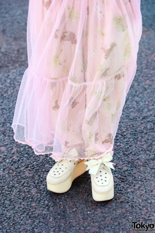 Japanese art student Akane on the street in Harajuku wearing a pink teddy bear themed vintage look w