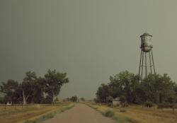 lavastormsw:  darrynek:  kylejthompson:  I found a ghost town while driving though the midwest. I spent the day wading through dead grass and exploring the vacant homes.  A rusty water tower lay on the outskirts of the town and the yards were littered