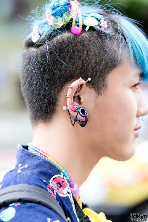 tokyo-fashion:  6%DOKIDOKI shop staff Kanata on the street in Harajuku wearing a Kinji Hello Kitty jacket over a manga-print top from Park Harajuku, piercings, mismatched socks, and 6%DOKIDOKI hair accessories. Full Look