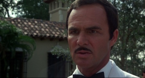 Stick (1985) -  Charles Durning as ChuckyAs I look at the bad wig, fake bushy eyebrows and the 