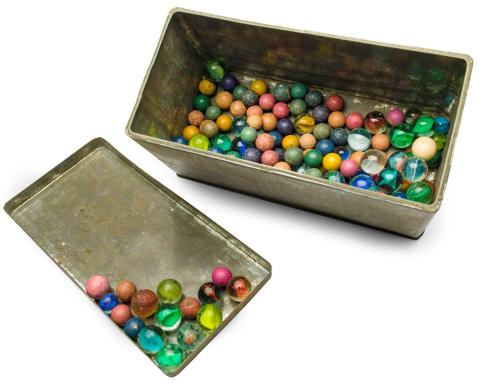 blondebrainpower:A tin box of marbles that