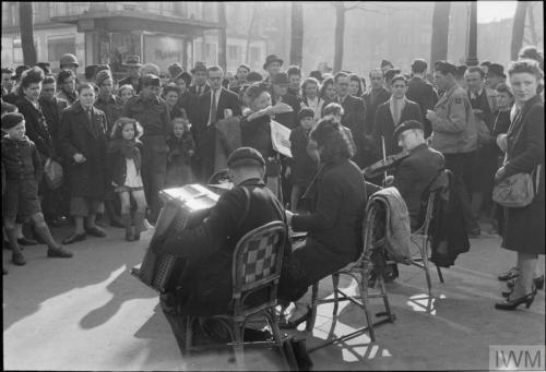 Everyday life in liberated Paris (spring 1945):A large group of civilians queueing outside a bakery-