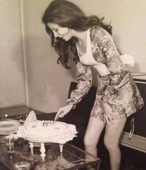 A woman cuts into her birthday cake in Tehran,