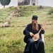 furordinaricvs:Serbian monk playing gusle in front of 13th c. Vranjina monastery. Lake Skadar, Montenegro. 