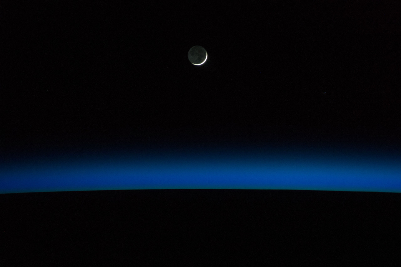 spaceexp:  A crescent moon and Earth’s horizon are featured in this nighttime image