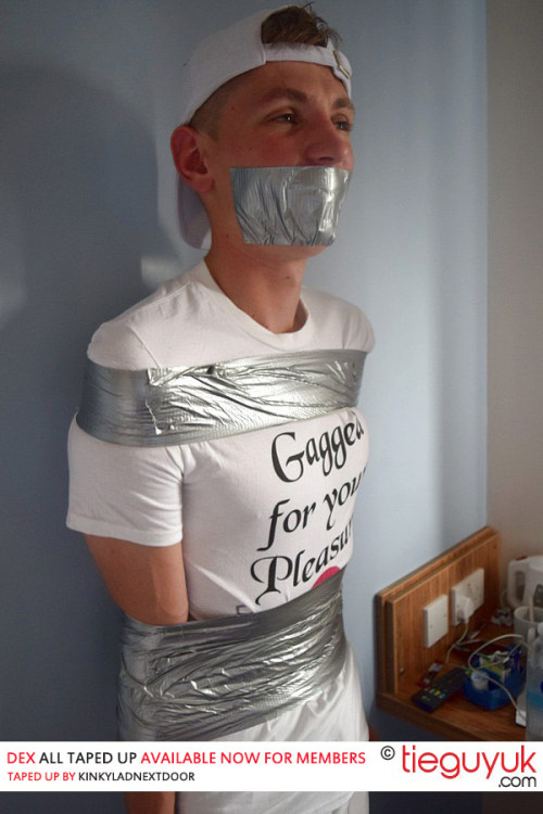 tieguyuk:I love it when you can tell they’re grinning beneath the duct tape :-). Check out 18 year old Dex all taped up. Now online for members courtesy of kinkyladnextdoor.