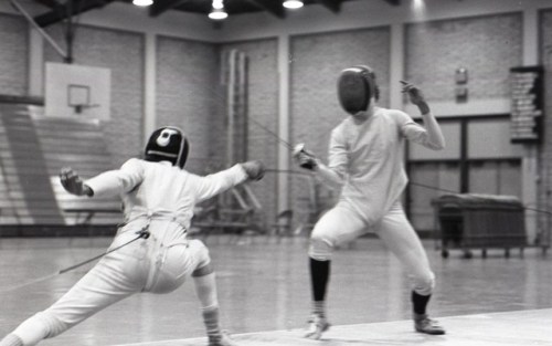 [ID: a foilist lunging as his opponent advances.]Terry Cohen (left) against Steve Goldbeck at the Bu