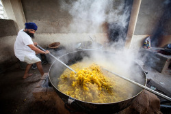 radicalqueerbrownboy:artofprayer:A cook in a Sikh kitchen cooking curry in an extremely large pot.The Sikh kitchen provides tens of thousands of free meals on a daily basis  This is what love looks like.