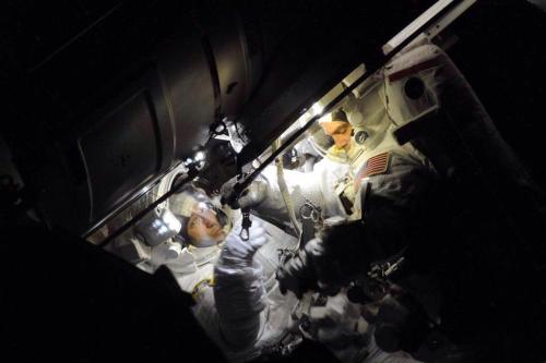 colchrishadfield:  Good morning! Cosmonaut Oleg Kotov’s photo of Rick & Mike as they started their spacewalk. The endless blackness.  