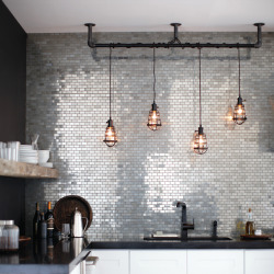 designmeetstyle:  Industrial yet glamorous, old but new. Stainless steel mosaic tile is the perfect backsplash-turned-accent-wall in this glamorous kitchen. Pendant lighting suspended by black pipe mimics cage lights of the industrial-era to add vintage