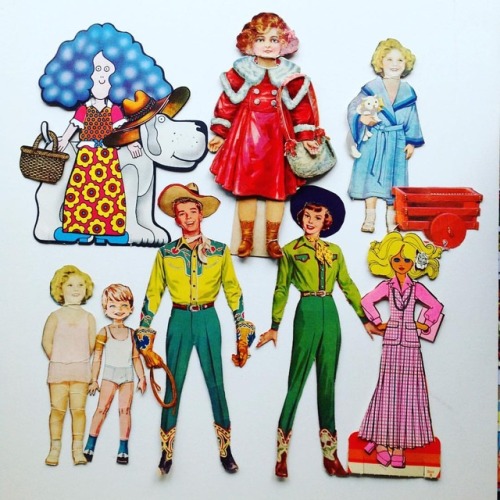 Paper dolls of different eras. I love it when the dolls are creased and furry from being played with