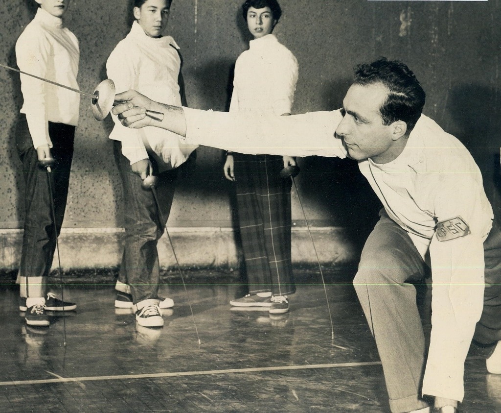 modernfencing:  [ID: two photos of a coach demonstrating a foil action to students,