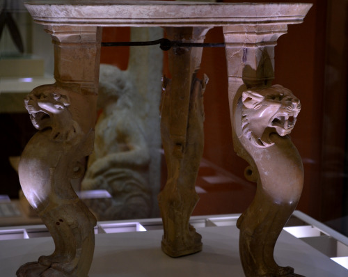 Archarological Museum of PatraA circular marble table with three legs. the short legs are decorated 