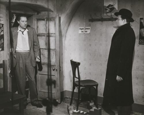 Director Carol Reed gives direction to Orson Welles on the set of The Third Man.