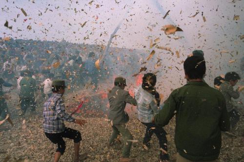 old-vietnam:Hanoi. 1989. In the debris of firecracker blast, young people in the village of Dong Ky,