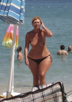 gilfsnmilfs:  21. Hot Beach Topless GILF showing off her Curvaceous Bod &amp; Splendidly Huge Tits  Mesmerizing hips
