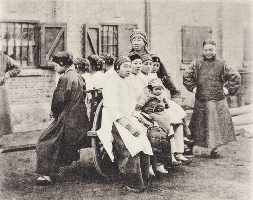 Image 1: Women and a child sitting on a wheelbarrow, an urban transport, in Shanghai, 1907. Referenc