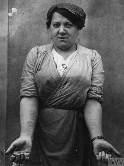 historical-nonfiction:A Scottish factory worker, showing off her tattoos in July of 1917. On her rig