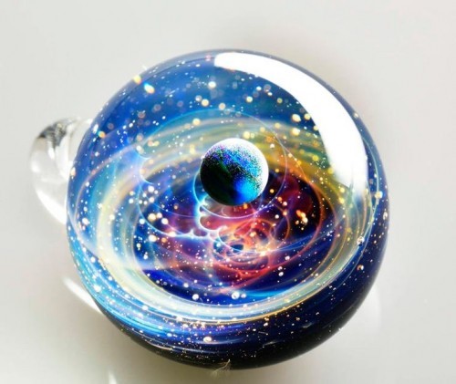 zombies-with-radios:  http://plusalpha-glass.com/index.html  Artist Satoshi Tomizu creates small glass spheres that appear to be miniature solar systems or galaxies, in which planets made of opal are circling into spirals of colored glass and gold flakes.