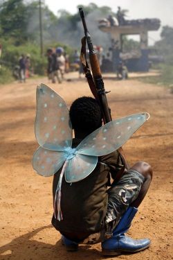 letswakeupworld:  A child soldier wearing butterfly wings - Lord’s Resistance Army, Uganda 