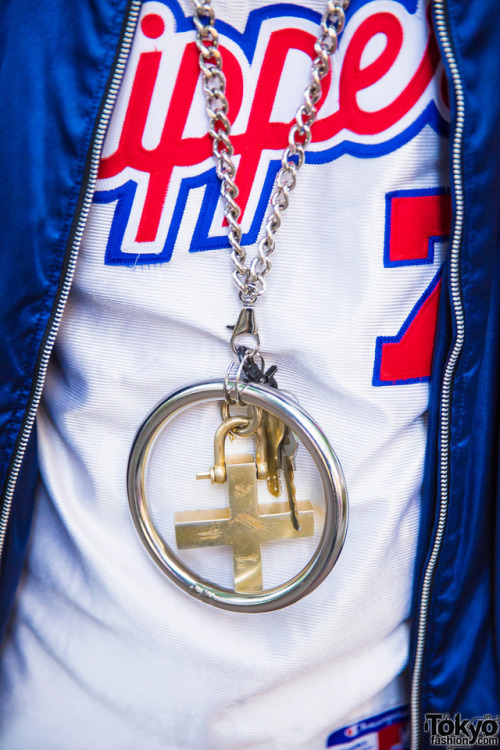 21-year-old Japanese graphic designer TKM Freedomon the street in Harajuku wearing a vintage jacket 