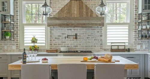 #BagoesTeakFurniture Kitchen with exposed brick backsplash, exposed brick walls and kitchen hood mad