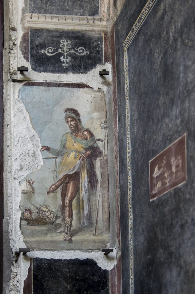 commiepinkofag:Priapus, the god of fertility and abundance, with a scale and bag of money, depicted on the wall of an ornate house owned by two men in ancient Pompeii — freed slaves and wine merchants, Aulus Vettius Restitutus and Aulus Vettius Conviva.
