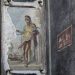 commiepinkofag:Priapus, the god of fertility and abundance, with a scale and bag of money, depicted on the wall of an ornate house owned by two men in ancient Pompeii — freed slaves and wine merchants, Aulus Vettius Restitutus and Aulus Vettius Conviva.