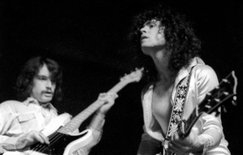 Steve Currie and Marc Bolan getting it on and banging a gong.