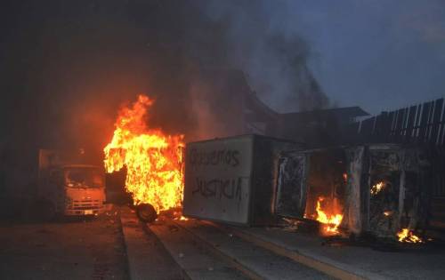 micdotcom:  Intense photos capture the protests happening in Mexico right now  Protesters set fire to the wooden door of Mexican president Enrique Peña Nieto’s ceremonial palace in Mexico City late Saturday night, demanding justice for the massacre