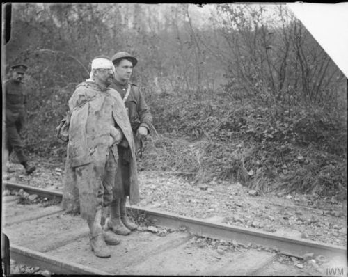 scrapironflotilla: A Military Policeman with a wounded German prisoner captured at St. Pierre-Divion