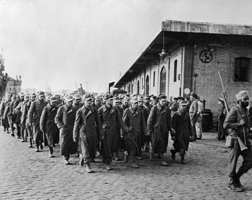 A Sikh soldier of the 8th Indian Army leads a group of German POW&rsquo;s, World War II.