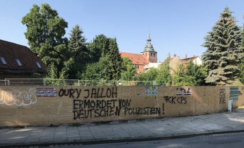 Memorial graffiti and posters across Germany for Oury Jalloh, a refugee from Sierra Leone who was bu