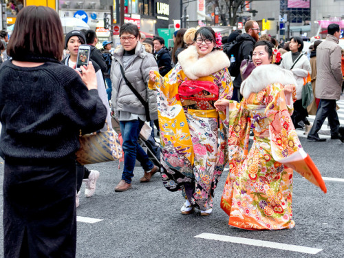 Young Japanese women celebrating Coming of Age Day (成人の日) 2018 with a big leap in the middle of Toky