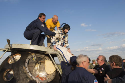 Samantha Cristoforetti is helped down from Soyuz TMA-15M shortly after landing in Kazakhstan, 11 Jun