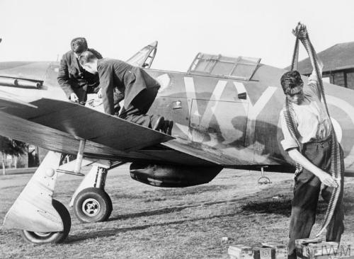 Pilots of &lsquo;B&rsquo; Flight, No. 32 Squadron, relax on the grass at RAFHawkinge in front of a H