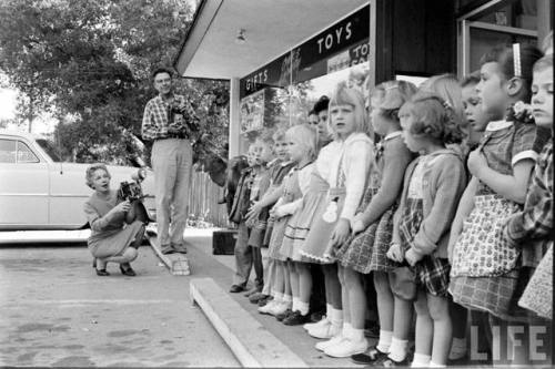 Taking a photo in front of Toyland(Ralph Crane. 1961)