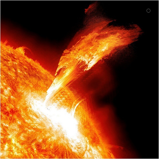 Solar flare erupting 400,000 miles into space &hellip; the small grey circle