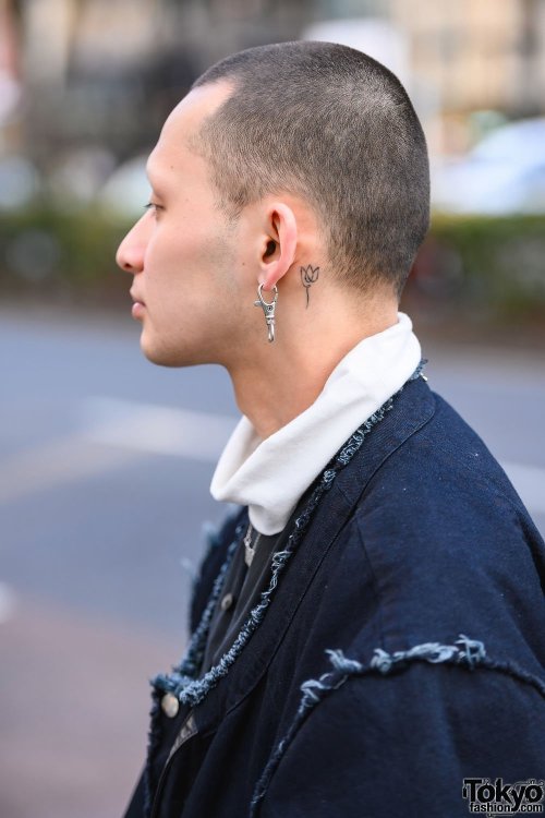 Japanese apparel worker Takamitsu on the street in Harajuku wearing a jacket and top from Not Conven