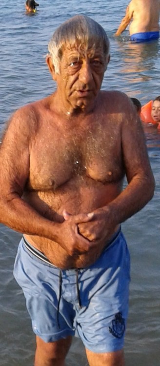 Hairy Granddad coming out of the water