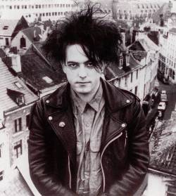 three-imaginary-chickens: Robert Smith, on a roof in Brussels 1987. From uncut magazine, thecure.cz 