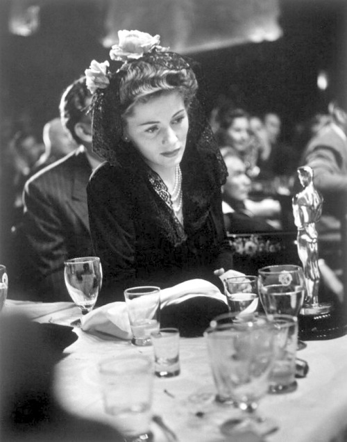 vintage-every-day: At the 1942 Academy Awards, Joan Fontaine gazes at the Best Actress Oscar she won