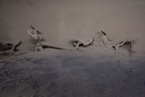 Rodrigo Abd captures bicycles standing in the hall of a home covered by ash from the Fuego volcano i