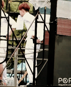  Kyungsoo taking his mic out while holding his name tag in his mouth    