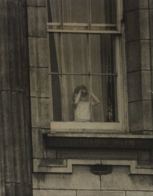 This photograph shows Prince Charles looking out of the window at Buckingham Palace on the day of hi