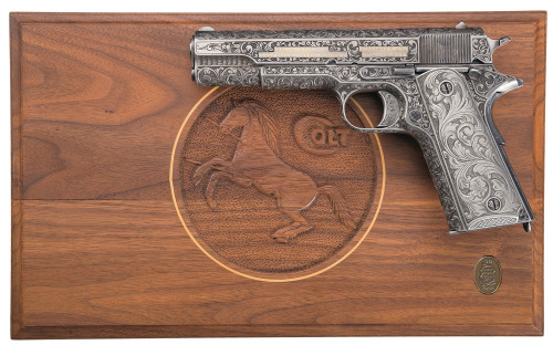 An early production US Colt Government Model semi automatic pistol engraved by Richard Roy. 