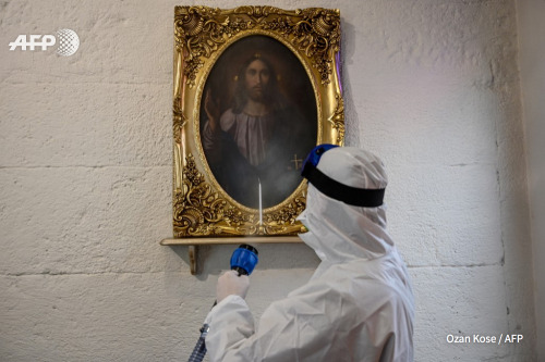 Worker with Istanbul’s Metropolitan Municipality disinfects the Panagia Altimermer Church, on March 